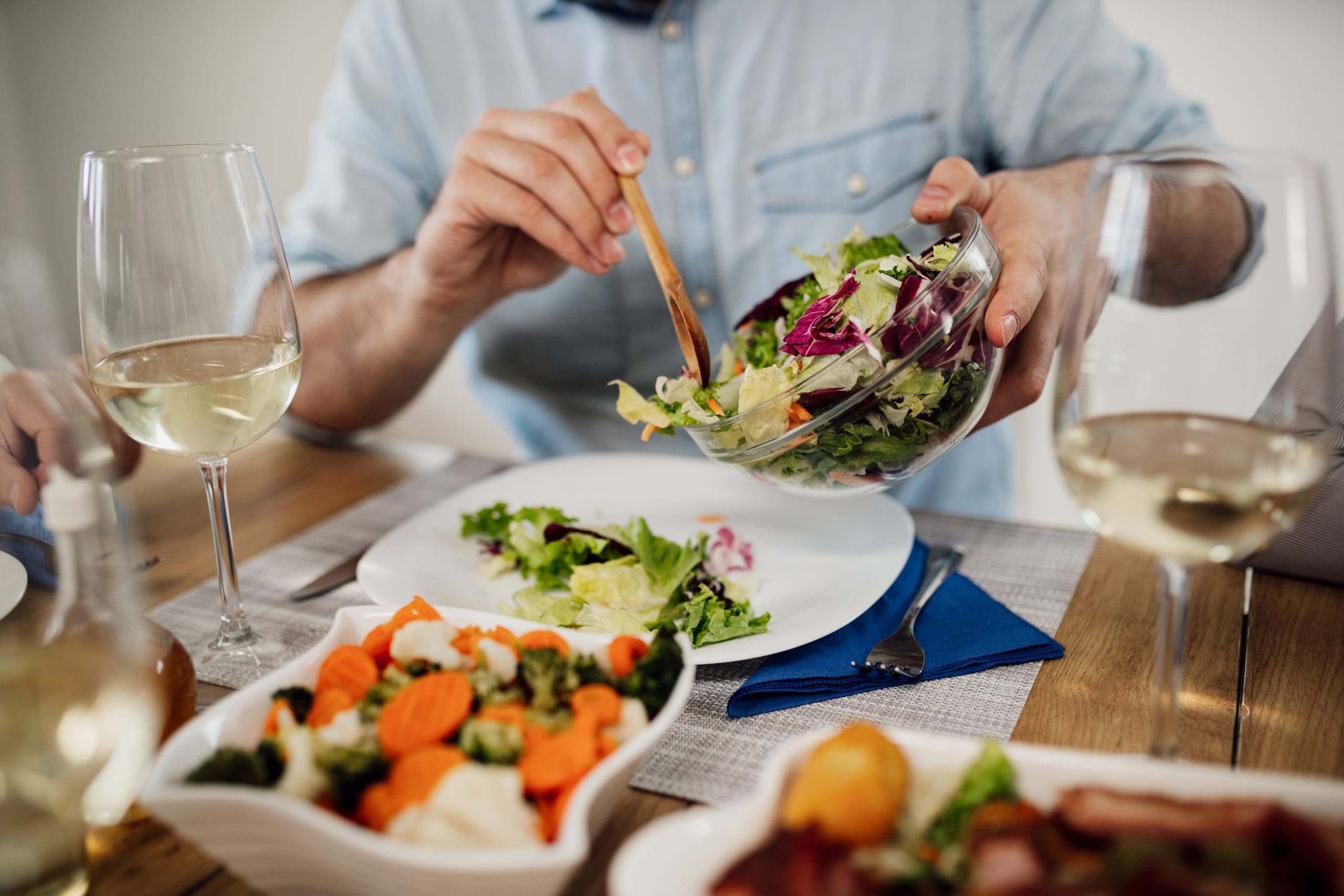 Close-up of man pouring salad while having lunch at dining table https://www.freepik.com/free-photo/closeup-unrecognizable-man-pouring-salad-plate-while-eating-lunch-dining-table_26652211.htm#fromView=search&page=2&position=23&uuid=2b62b1da-3466-4775-bf01-55db2c2b7e64&query=eating